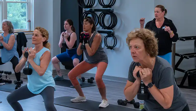 Group fitness classes including barre TRX cardio and strength training at Pilates and wellness studio in Harvard MA