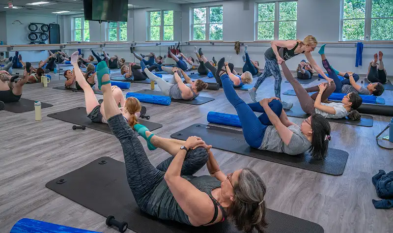 Pilates mat class focusing on core strength, posture, flexibility, and controlled body movement